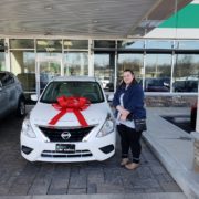 Natco Member next to her new car from Enterprise