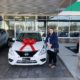 Natco Member next to her new car from Enterprise