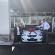 Member and salesman with new car