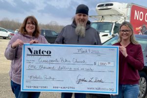 Natco staff presents a check to the Crosspointe Biker Church