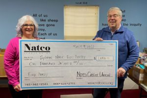 Natco staff present check to Sylvan Nook Food Pantry