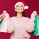 women wearing a santa hat and holding several gift bags