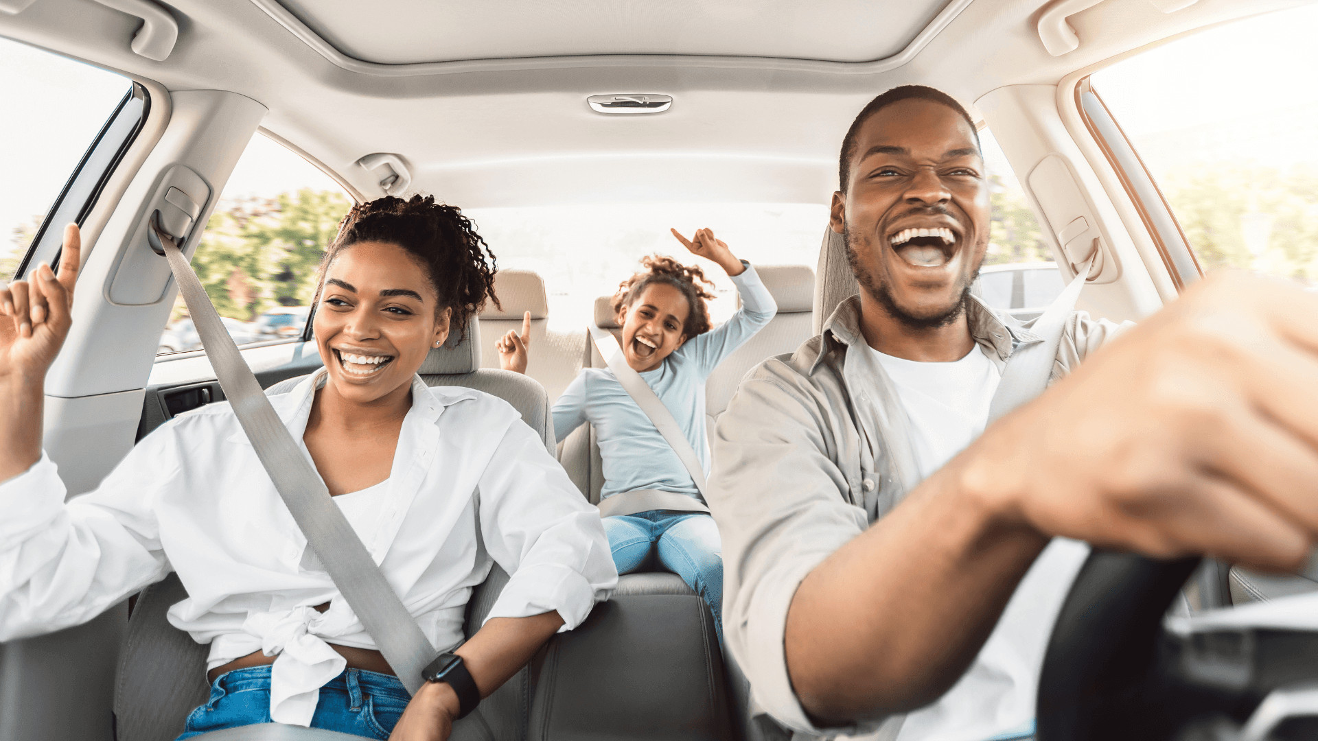 family in car singing along to radio