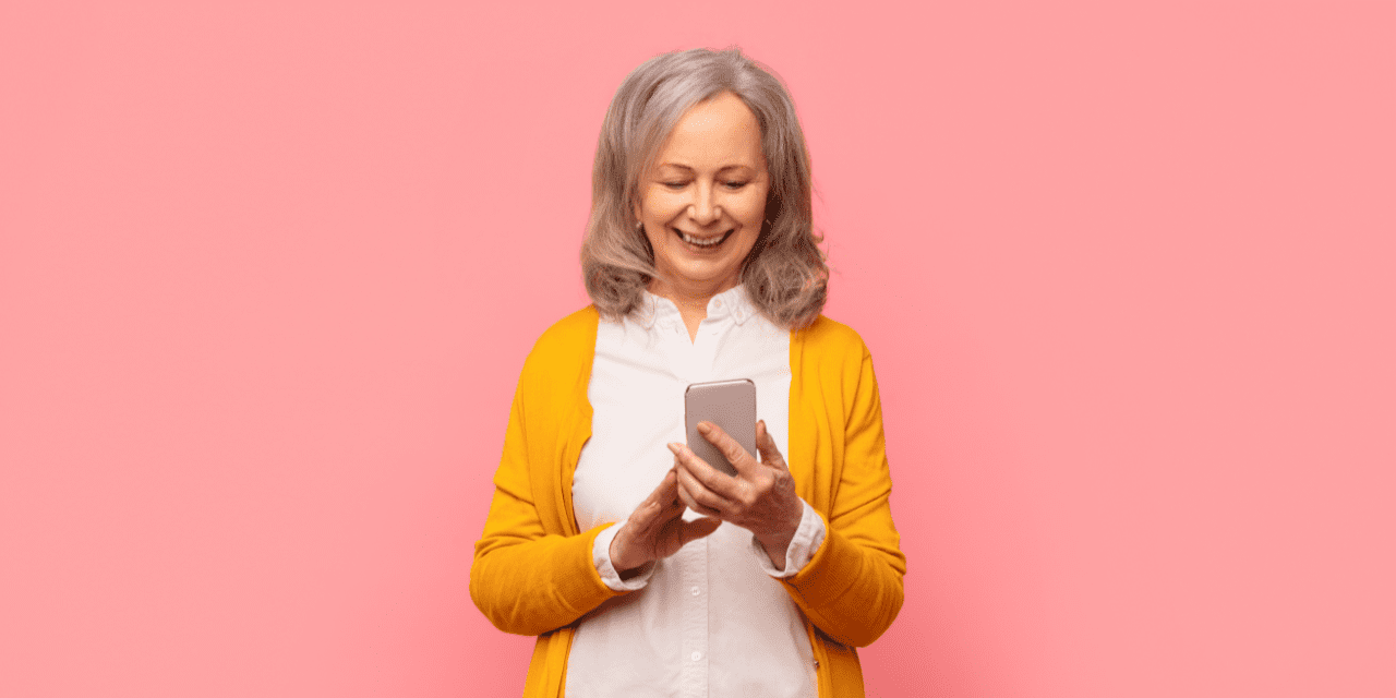 older lady holding a cellphone and smiling