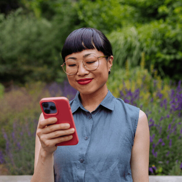woman looking confidently at phone