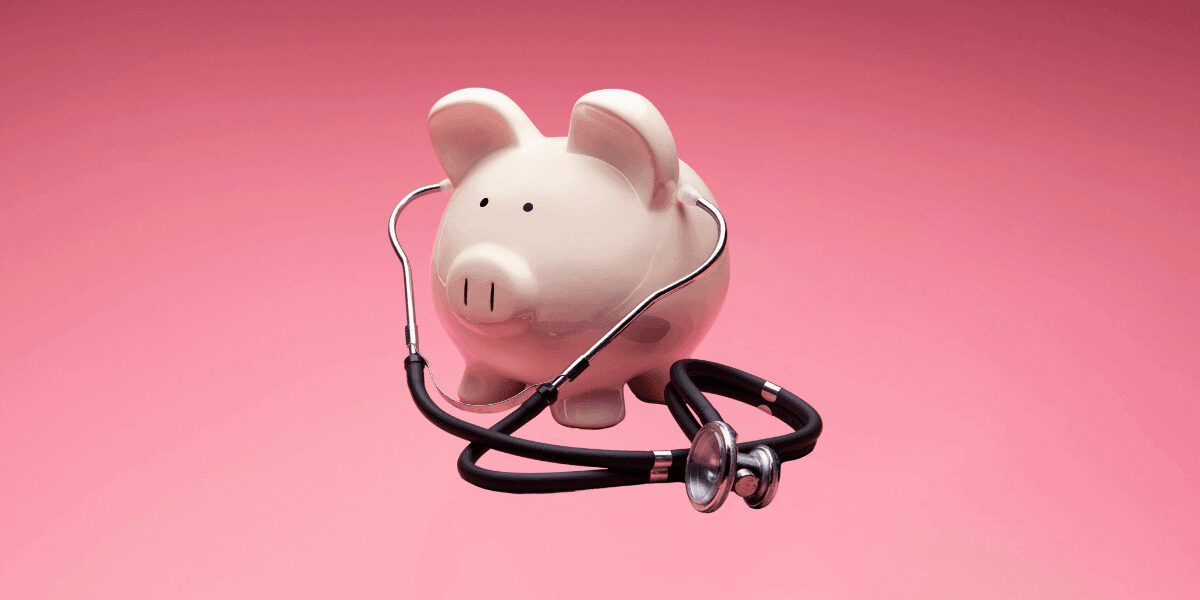 piggy bank listening to stethoscope on isolated background